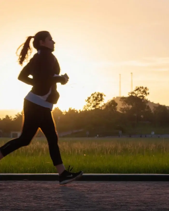 Woman running at golden hour