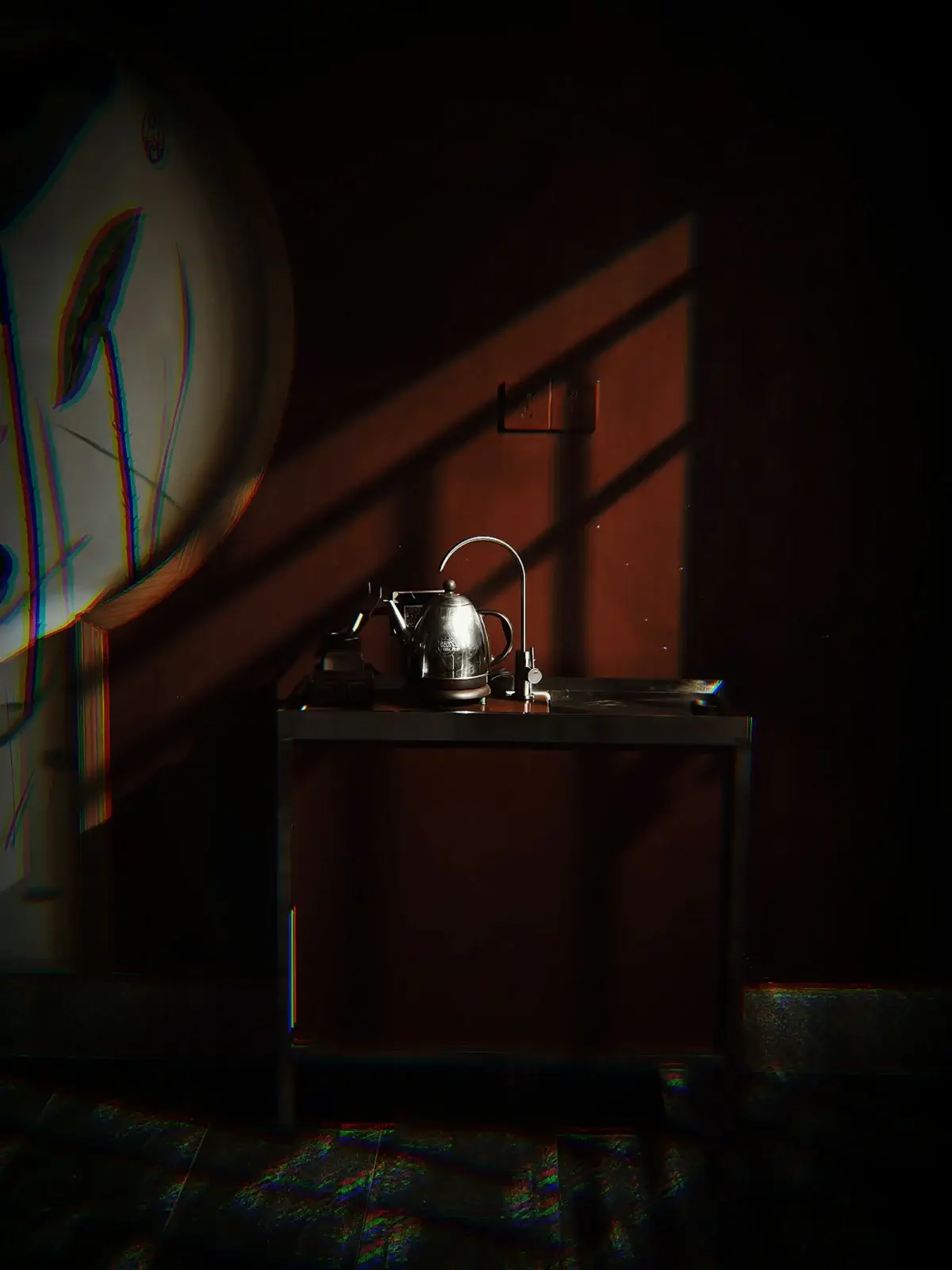 Kettle on a dark countertop in dramatic light